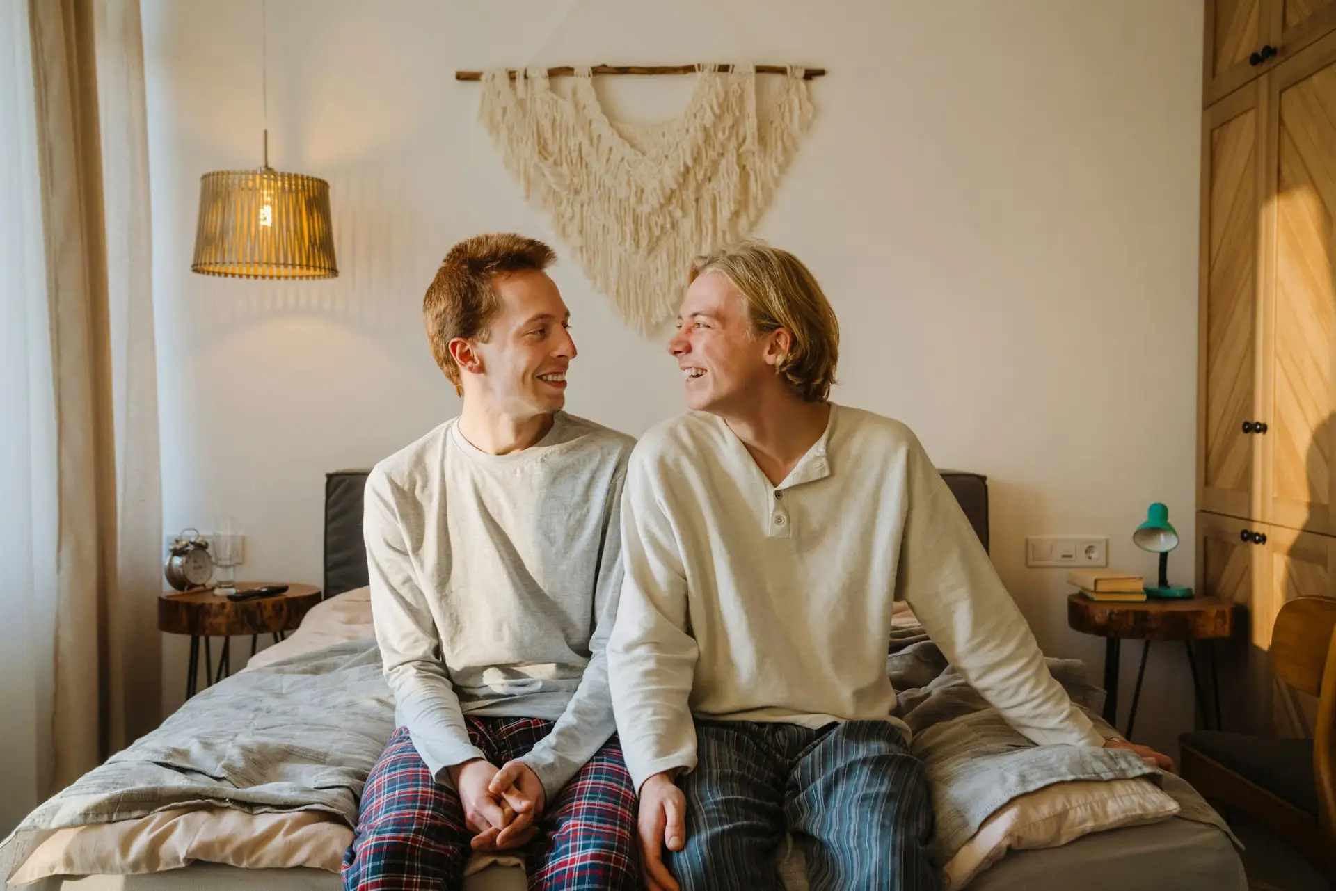 Young gay couple laughing and looking at each other