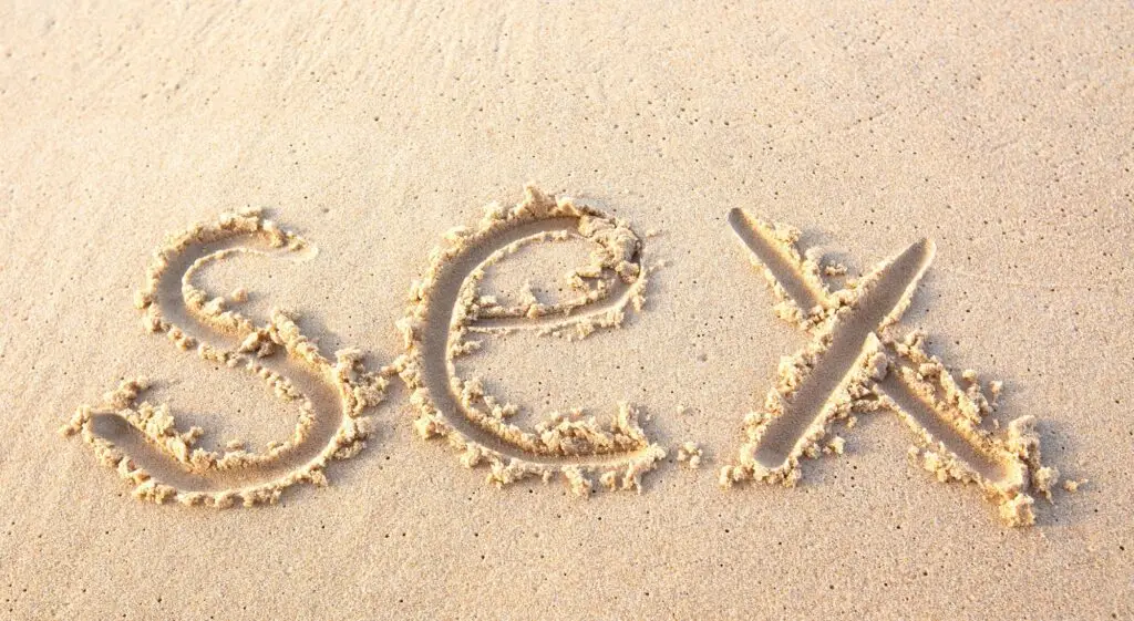 word "sex" written on beach sand